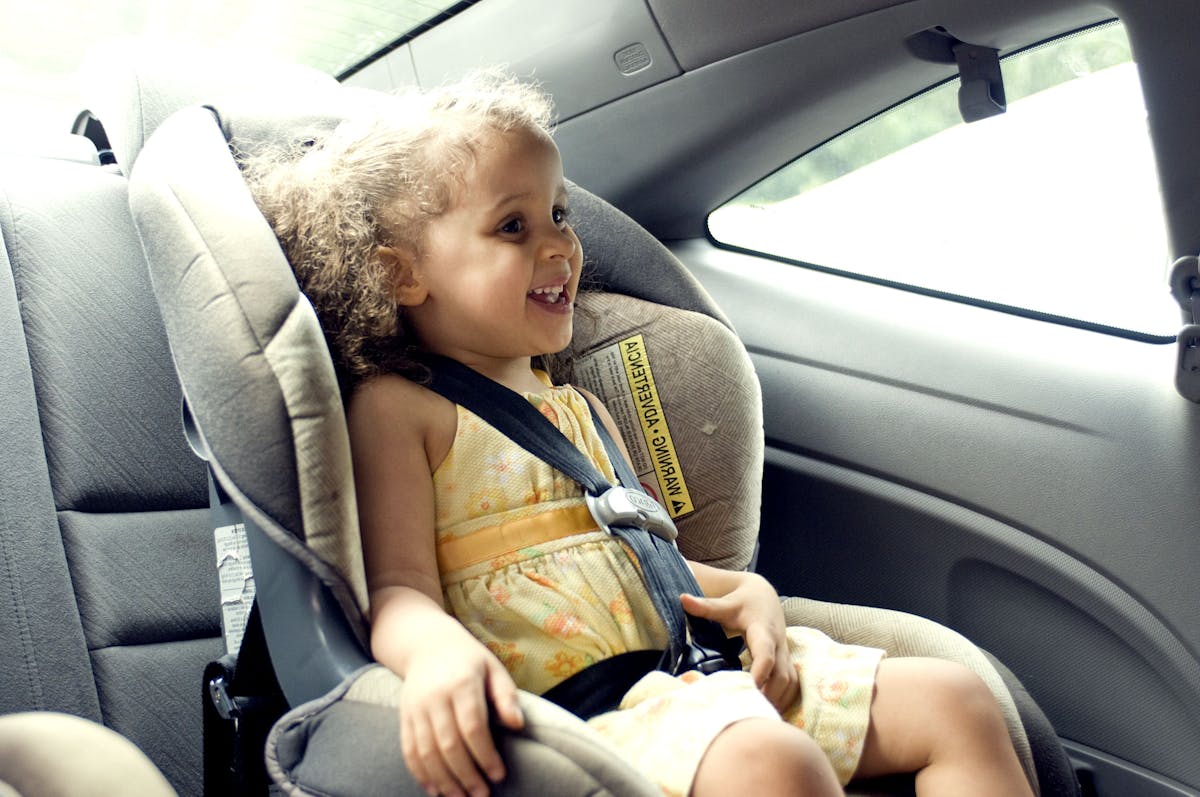 Child in the back seat of a car